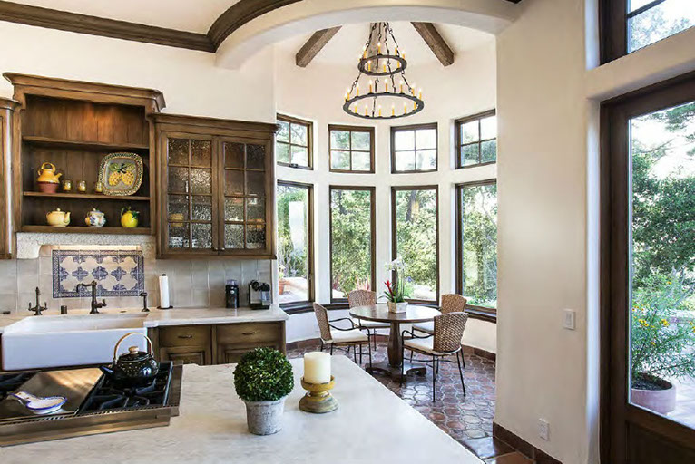 Spanish kitchen with iron-tier chandelier
