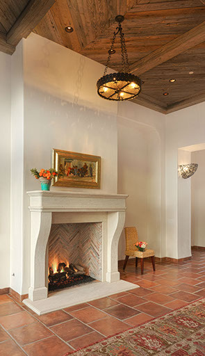 Stone fireplace room with iron pendant