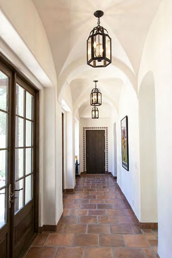 Vaulted hallway with iron lantern pendants